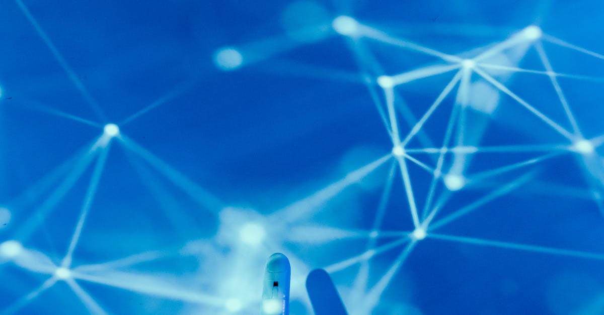 Futuristic robotic hand touching a digital network on a blue background.